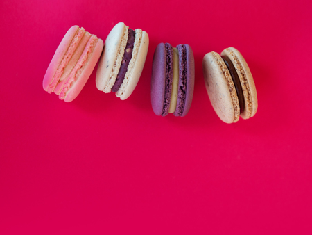 Set of colorful French macaroni cakes. Sweet almond cookies with different flavors. Free space and...
