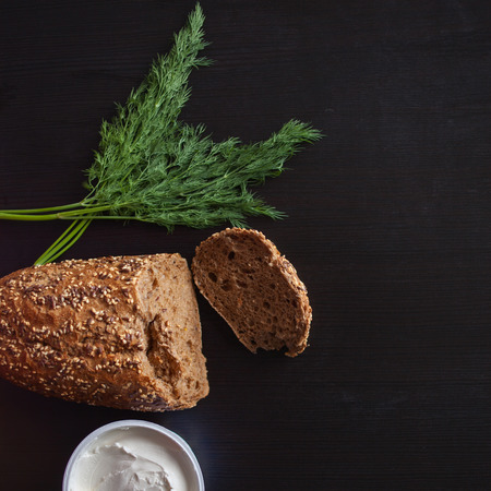 Loaf of multi-grain bread, cut into sandwiches. And cream cheese. Close-up, free space for text....