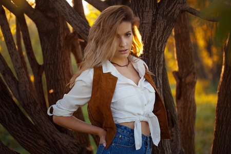 Cute charming girl in summer in the field. Young woman is happy and feels free, outdoorsの写真素材