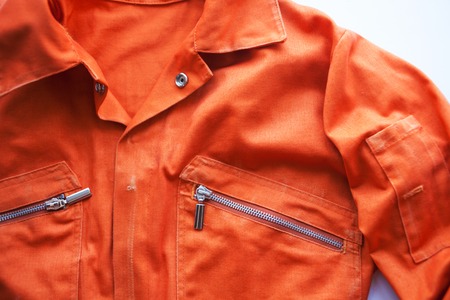 An orange jumpsuit of a prisoner. close up. Prison clothes, jumpsuit sentenced to correctional labor,community paybackの写真素材