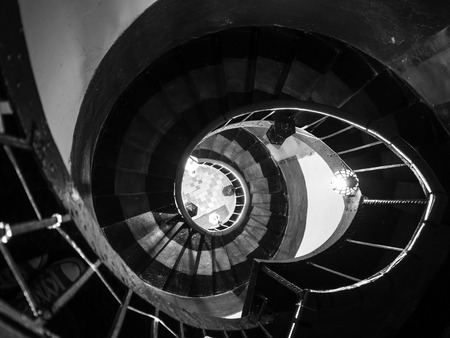 Old destroyed spiral staircase, black and white photo. Tower look upの写真素材