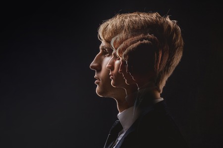 Self-confidence, psychological problems and complexes. Profile of a young man with a lot of personalities in the subconsciousの写真素材