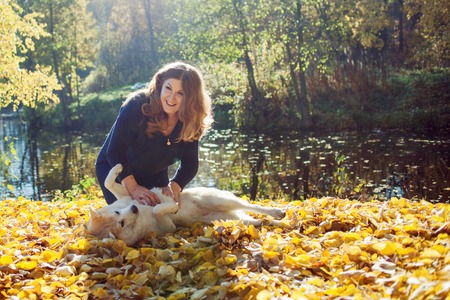 Young woman on a walk with her dog breed Akita inu. Friendship and love of human and dog