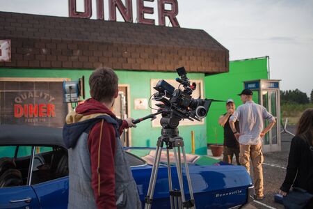 SAINT PETERSBURG, RUSSIA - OCTOBER 31, 2018: Film Crew On Location. 4K Camera Cinematographer. Filmmaking Set sceneryのeditorial素材