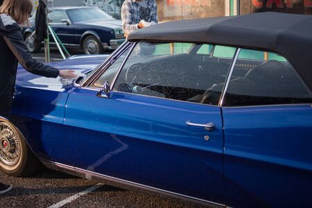 SAINT PETERSBURG, RUSSIA - OCTOBER 31, 2018: Retro car in the Parking lot. Pontiac Bonneville People Polish the hood of a retro carのeditorial素材