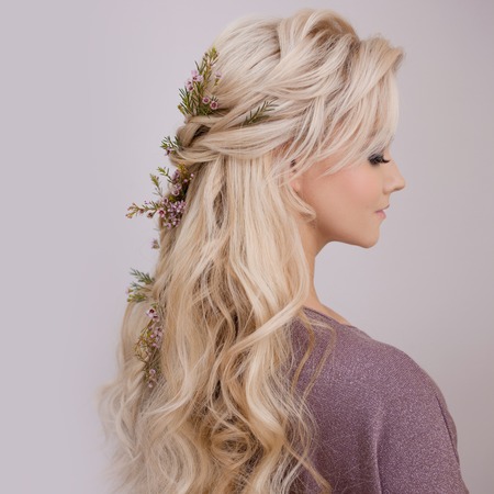 Portrait of an elegant young woman with blond hair. Trendy hairstyle, natural hair styling