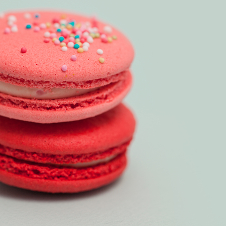 Bright delicious macaroons. French sweets. Pink cake on light blue backgroundの写真素材