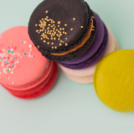 Beautiful bright macaroons. Sweet almond French dessert. blue backgroundの写真素材