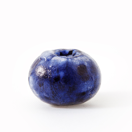 Fresh blueberry isolated on white.One big blueberry berry close-up with a drop on the sideの写真素材