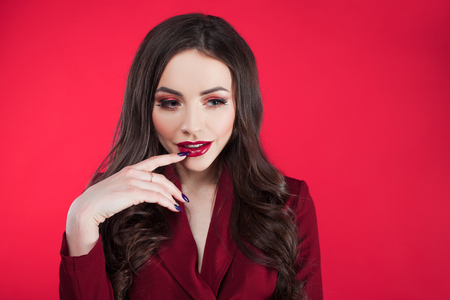 Attractive brunette one tone look. Portrait of Surprised attractive young woman on pink backgroundの写真素材
