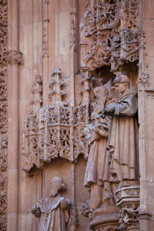 Medieval architecture. facade of the Cathedral is decorated with stone carvings and sculptures, in Salamanca, Spain.の写真素材