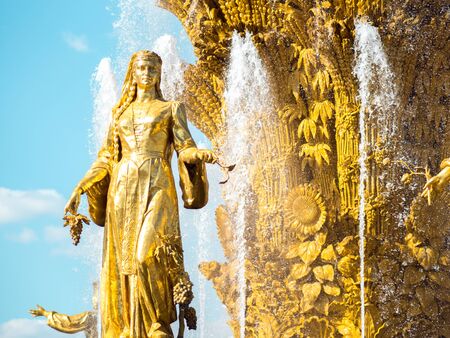 MOSCOW, RUSSIA - AUGUST 11, 2018: the people's friendship fountain at VDNKH. Gold female sculptures symbolizing the republics of the Soviet Unionのeditorial素材