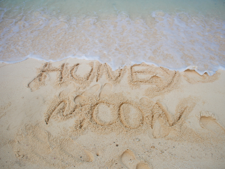 Surf and lettering honeymoon on the sand. Coast on a tropical island, honeymoon by the sea.の写真素材