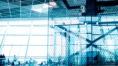 Modern airport terminal escalator up to the departures area. Waiting room before the flight