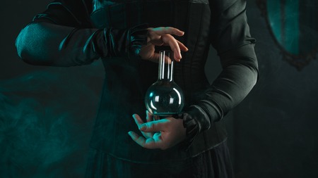 woman is a research scientist holding a flask with the material. Concept of scientific research and...