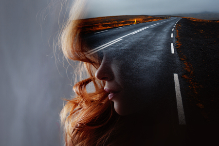 Profile of a young beautiful woman and the road, double exposure. Goal setting and dreams, concept.の写真素材