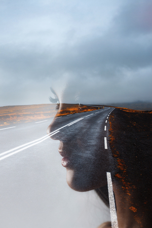 Profile of a young beautiful woman and the road, double exposure. Goal setting and dreams, concept.の写真素材