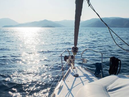 Boat trip on a yacht, a fragment of the deck and the mountains on the horizon, the view from the...