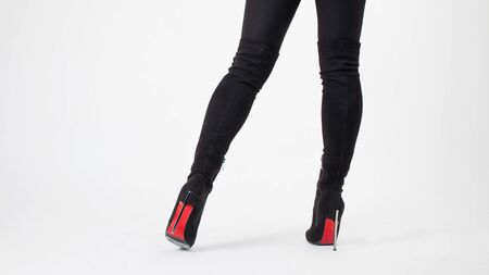 Slim legs in black boots and pants. Walking in high heels. Stiletto shoes, sexy styleの写真素材