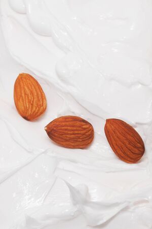 Almond milk. A lot of almonds and milk splash. Cream yogurt and almonds, healthy foodの写真素材