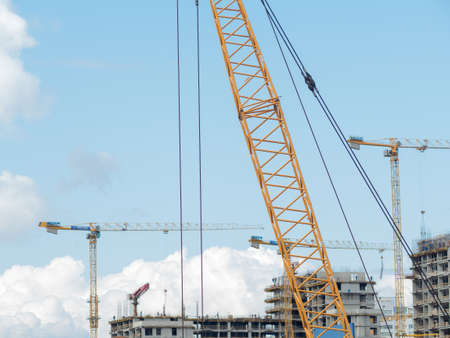 MOSCOW, RUSSIA - AUGUST 5, 2019: Construction of high-rise building. Construction cranes and residential real estate quarter in process.のeditorial素材