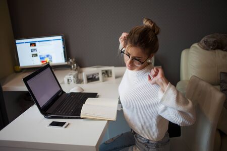 Freelance and remote work. Abnormal working hours, fatigue and muscle spasm due to a sedentary lifestyle.の写真素材