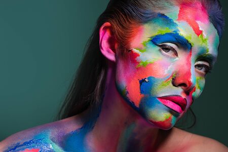 Face art and creative makeup, a young beautiful woman abstract art on the face, an unusual idea.