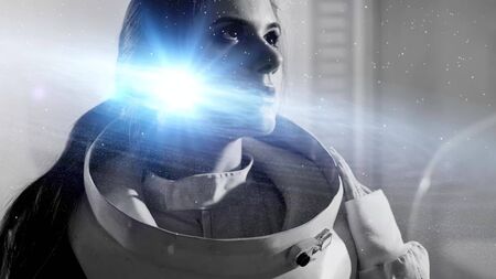 inner universe, a concept of human consciousness and intelligence. A young woman in a space suit and a galaxy in her brain, double exposureの写真素材