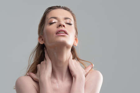 Wash your face and take care of your skin. Portrait of a young woman with beautiful clean skin, skin health, cleansing and moisturizingの写真素材