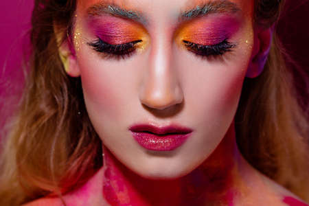 Bright makeup and face art, close-up portrait, girl with closed eyes. Creative makeup, an unusual...