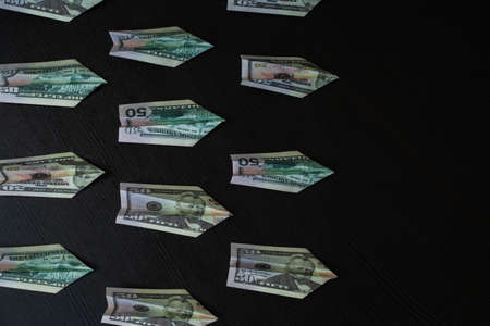 Paper planes made of dollar bills, usd cash flow concept. Investments in promising sectors of the economy, speculation in the foreign exchange marketの写真素材