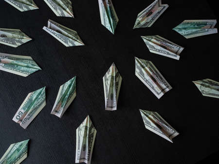 Paper planes made of dollar bills, usd cash flow concept. Global financial crisis, debt on loans,...