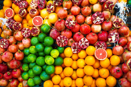 Oranges, grapefruits and pomegranates, a fruit counter. Lots of fresh juicy citrusの写真素材