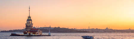 Maiden tower is a landmark in the Bay of Istanbul. Panorama of Istanbul and the coast with mosques, beautiful view of the evening city, sunsetの写真素材