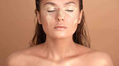 Concept portrait, planet is crying. Pigmentation on skin of young beautiful girl, face art in form of a map of world. Global problems, environmental and ethnic problems, global crisis and epidemicsの写真素材