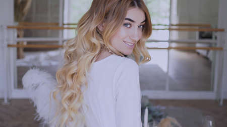 Beautiful elegant bride in a simple white wedding dress with sleeves, Close-up portraitの写真素材