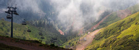 Mountain resort in summer, beautiful landscape, green valley between mountain peaks. Infrastructure...