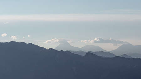 Panorama of the mountain range in the distance. Landscape in soft blue tones, sky and mountains