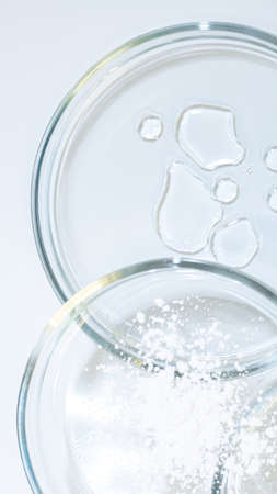 Serum for skin care, eco-friendly cosmetics. Bottles and ingredients for cosmetics on a white...