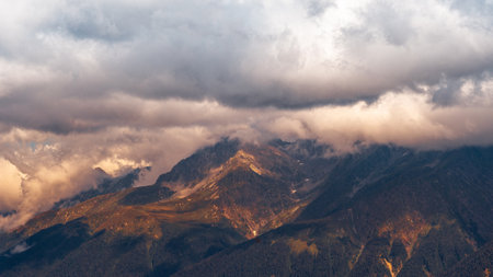 Beautiful mountain landscape. High-mountain massif, clouds over mountain peaks. Harsh mountain peaks in the clouds, the power of natureの写真素材