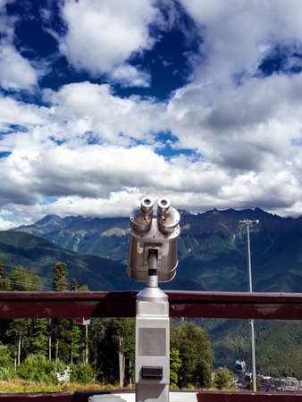 Binoculars on the viewport in the mountains. Look into the distance, beyond the horizon.