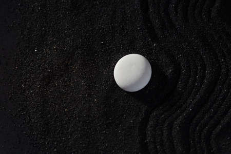 rock garden white pebbles on black sand, wavy patterns.の写真素材