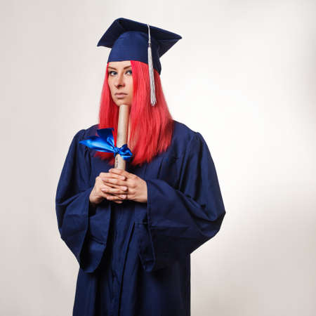 disappointed graduate with a diploma in hands, depression and confusion