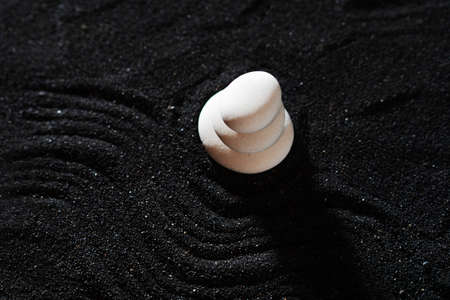 rock garden, white pebbles on black sand, wavy patterns.