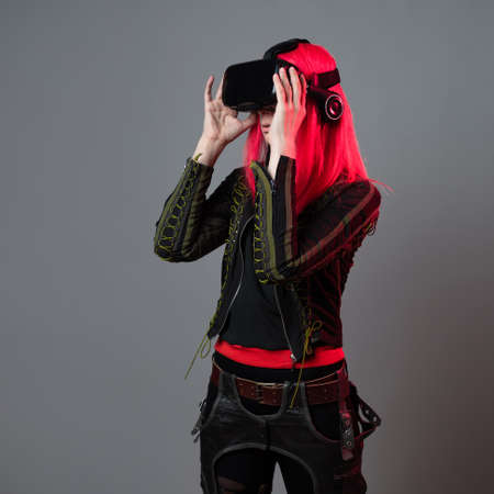 Stylish young gamer in a virtual reality helmet, playing in simulations,