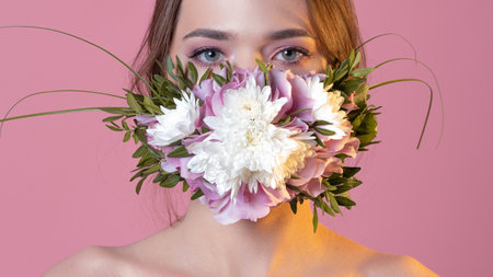 Young beautiful woman in a flower face mask,の写真素材