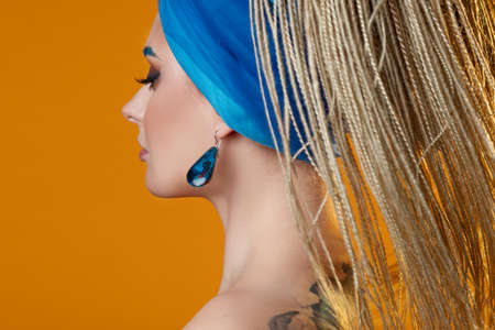 Creative makeup with bright blue eyebrows and blue eyeliner,
