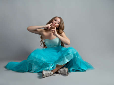 beautiful and daring princess in a lush blue Cinderella dress