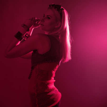 Disco style, young attractive woman in retro style outfit dancingの写真素材