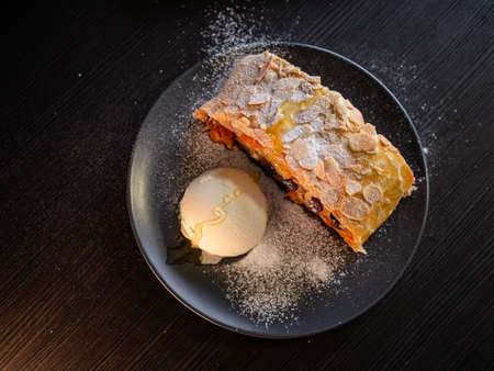 Delicious fresh strudel stuffed with apples and raisins,の写真素材